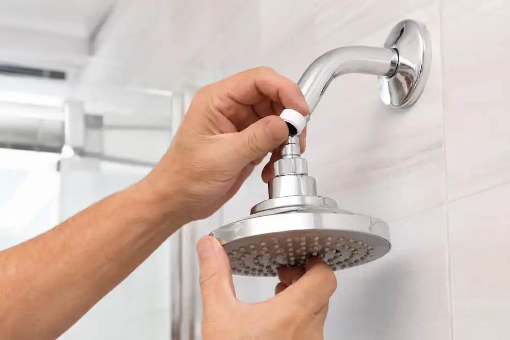 Installing a low-flow showerhead to reduce water use.